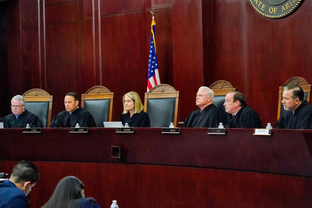 Arizona Supreme Court Justices (L–R) William G. Montgomery, John R. Lopez IV, Vice Chief Justice Ann A. Scott Timmer, Chief Justice Robert M. Brutinel, Clint Bolick, and James Beene listen to oral arguments in Phoenix, on April 20, 2021. (Matt York, File/AP Photo)