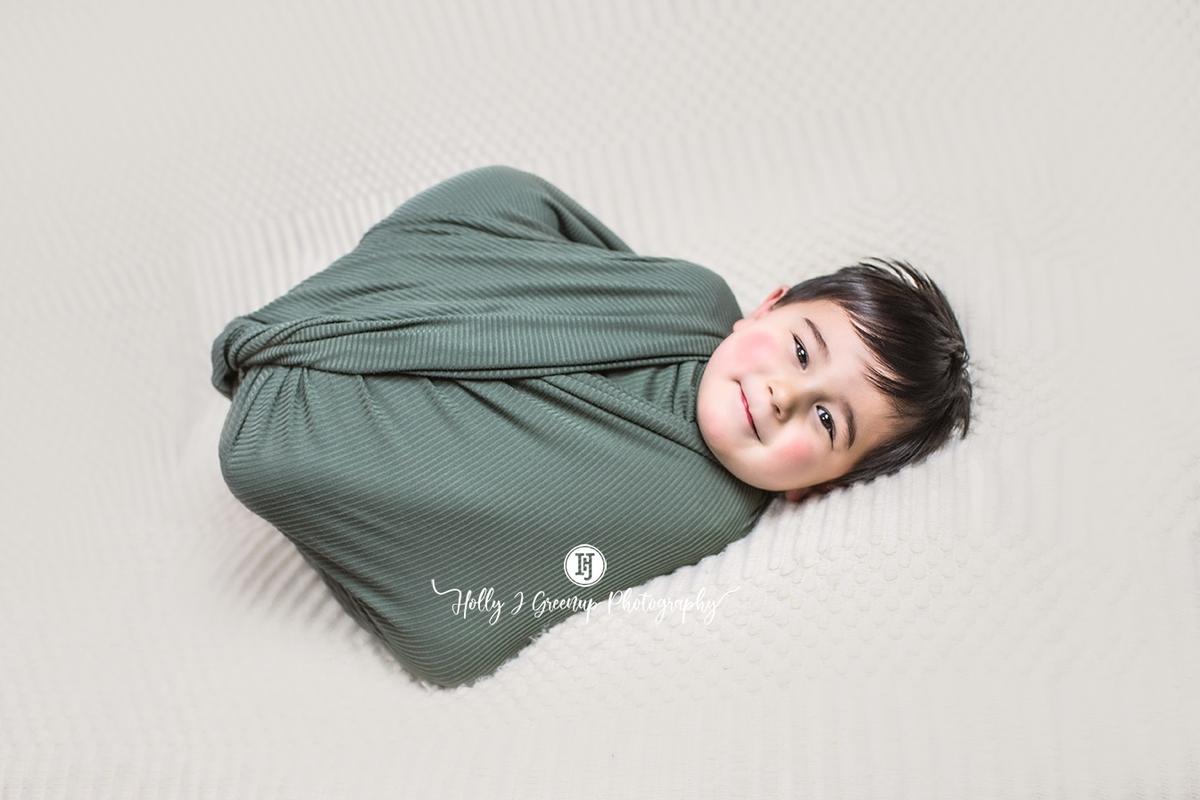 Vincent swaddled like a baby. (Image by <a href="https://www.hollyjgreenup.com/">Holly J Greenup Photography</a>)