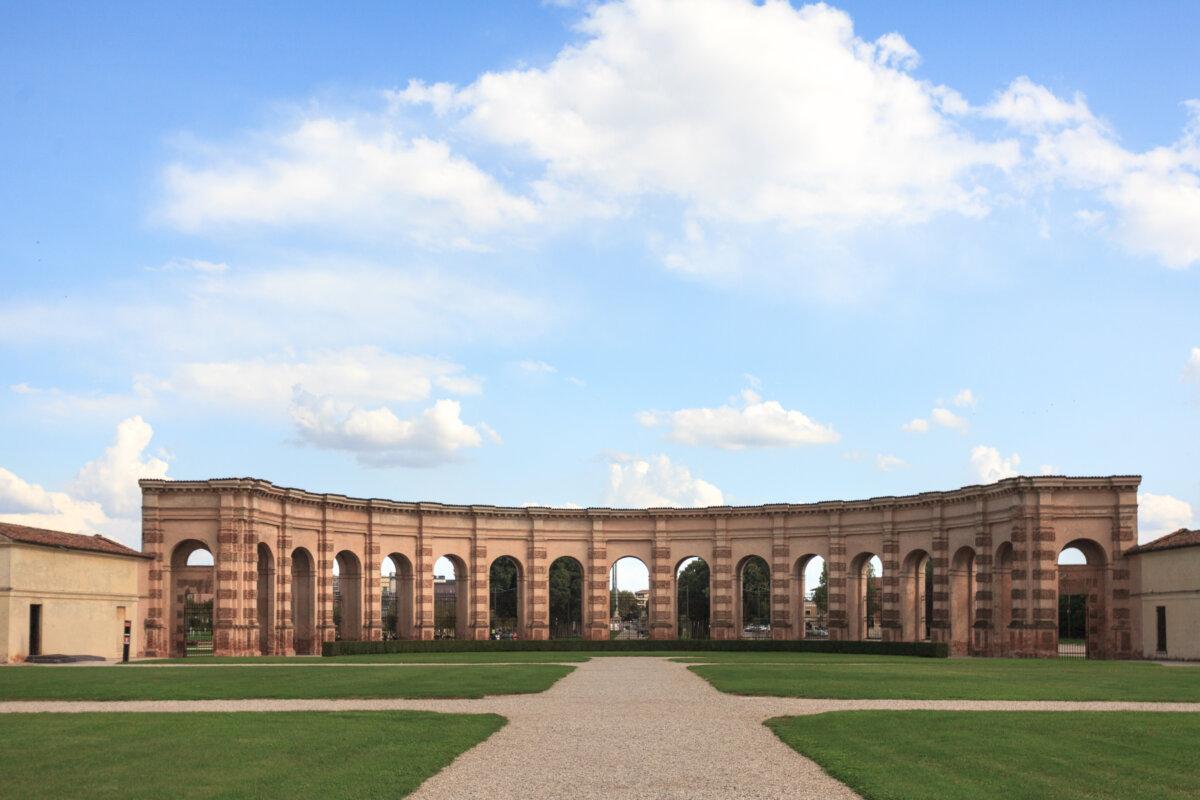 An Esedra, a semicircular double colonnade of a series of arches, is a focal element that holds the space, and completes the expansive Courtyard of Honor. A door to the secret garden is visible on the far left. (J.H. Smith)